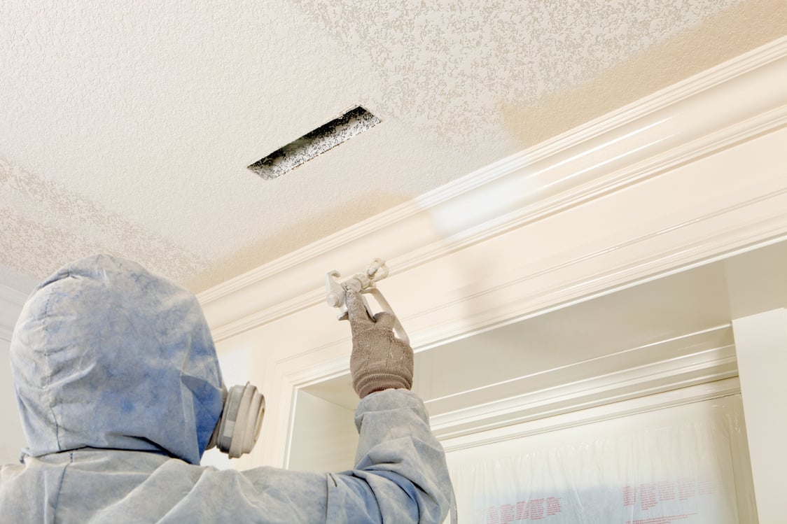 Painter Spraying Paint on Crown Moulding